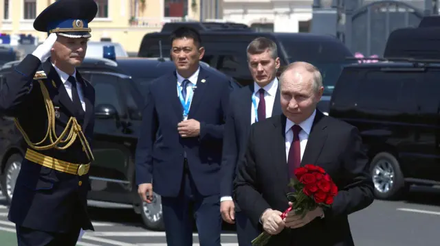 Russian President Vladimir Putin takes part in a flower-laying ceremony at a monument to Soviet soldiers, who died in battles for the liberation of China, in Harbin