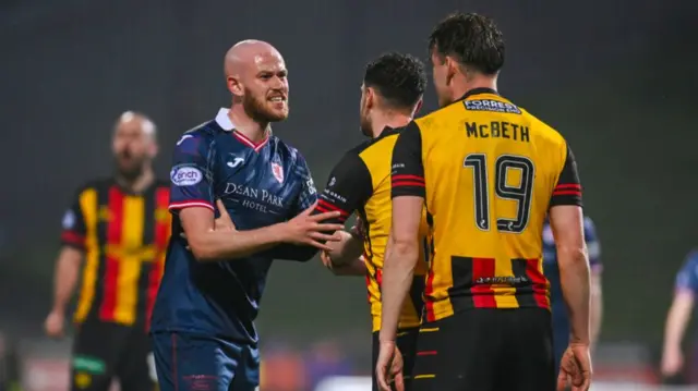 Raith Rovers' Zak Rudden exchanges words with Partick Thistle's Luke McBeth during a cinch Premiership play-off semi-final first leg match between Partick Thistle and Raith Rovers at Wyre Stadium at Firhill, on May 14, 2024, in Glasgow, Scotland.