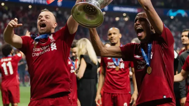 Xherdan Shaqiri and Joel Matip lift the Champions League trophy