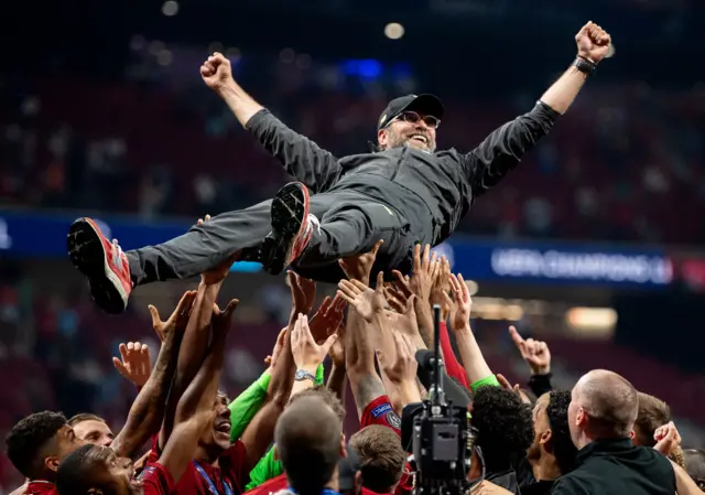 Liverpool players hold Jurgen Klopp aloft after winning the 2019 Champions League final