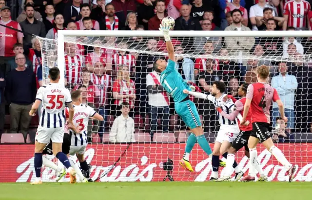 Southampton goalkeeper Alex McCarthy (centre) makes a save