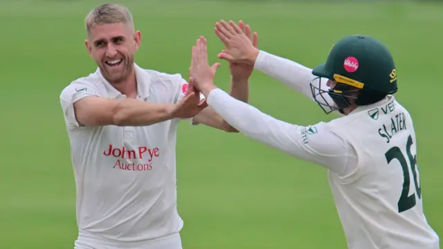 Olly Stone celebrates taking a wicket