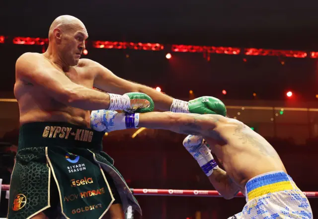 Oleksandr Usyk lands a body punch on Tyson Fury