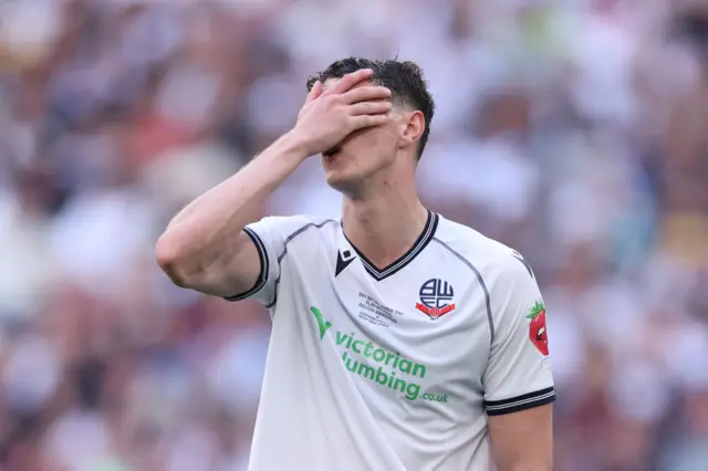 Eoin Toal of Bolton Wanderers pits his hand to his face in despair