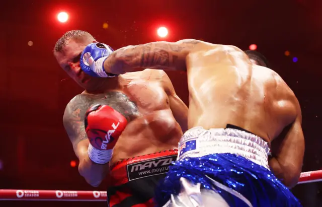 Blood flies from the nose of Mairis Briedis after a hit from Jai Opetaia