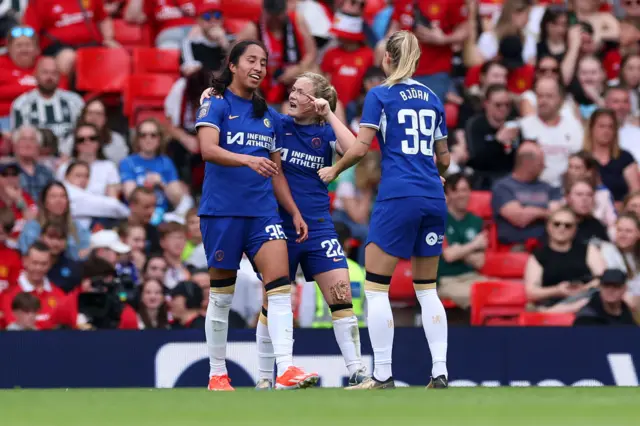 Mayra Ramirez of Chelsea celebrates with teammates Erin Cuthbert and Nathalie Bjorn after scoring her team's fourth goal during the Barclays Women´s Super League match between Manchester United and Chelsea FC