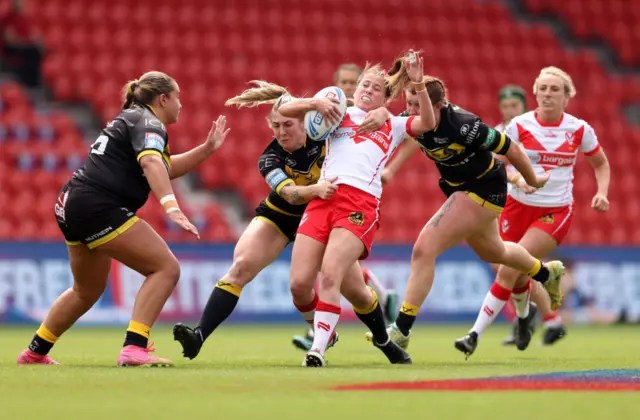 St Helens' Tara Jones is tackled by Alex Stimpson