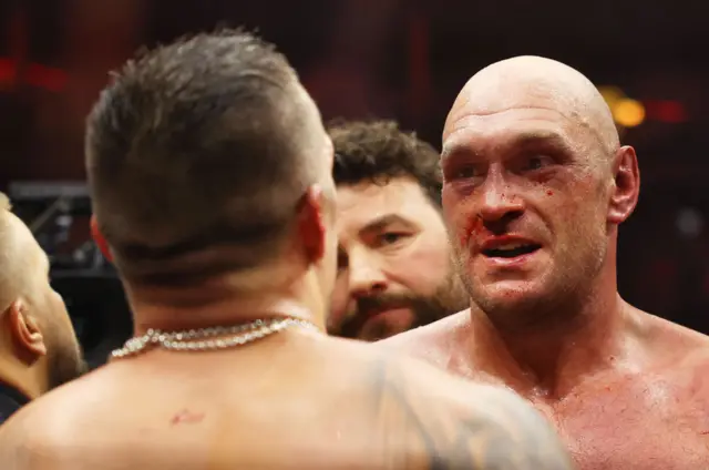 Oleksandr Usyk and Tyson Fury talk in the ring