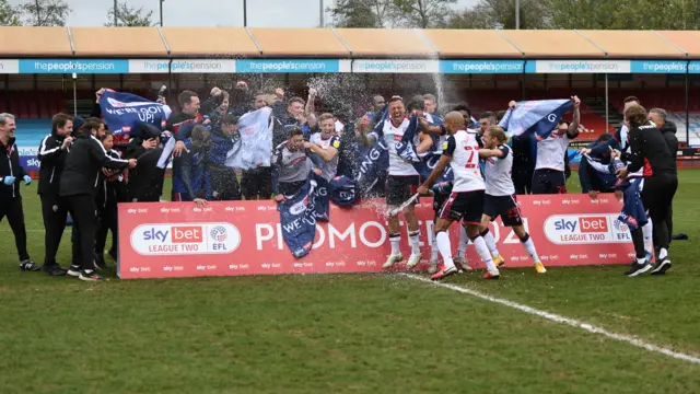 Bolton players celebrate promotion from League Two