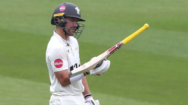 Rory Burns looks at his bat