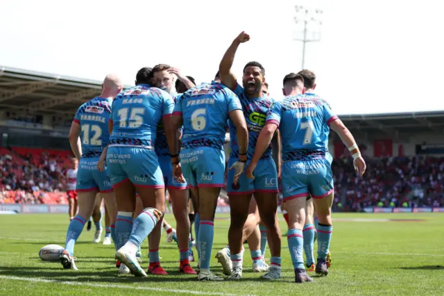 Wigan celebrate a try against Hull KR