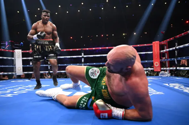 Francis Ngannou stands over Tyson Fury