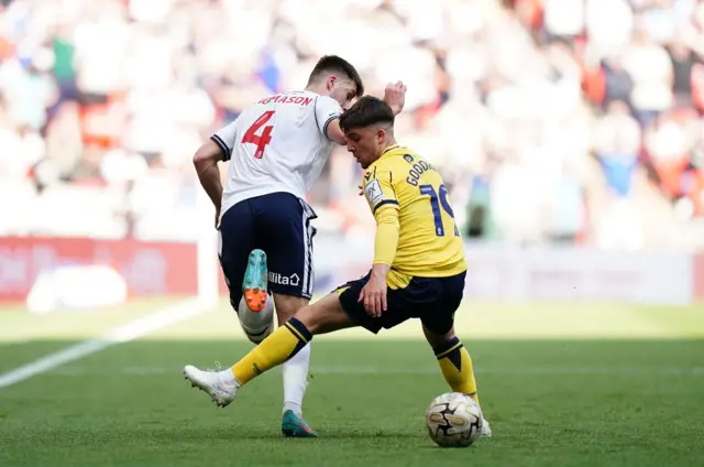 Bolton Wanderers' George Thomason in action against Oxford United's Tyler Goodrham