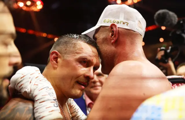 Oleksandr Usyk hugs Tyson Fury