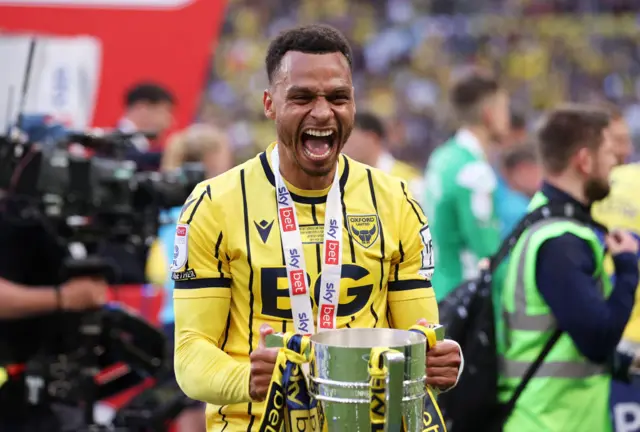 Josh Murphy celebrates with the League One play-off trophy