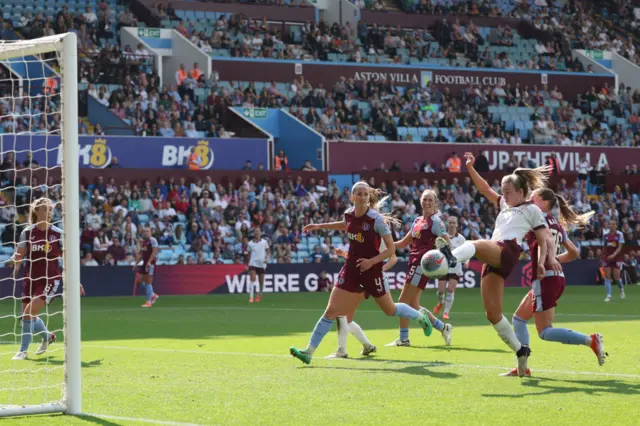 Lauren Hemp (2R) shoots to score their second goal during the English Women's Super League football match between Aston Villa and Manchester City at Villa Park