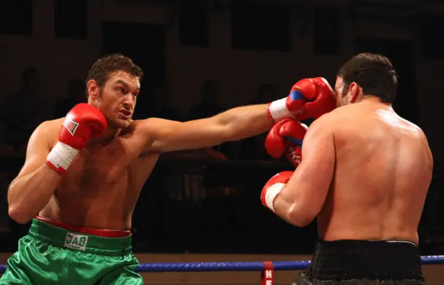 Tyson Fury throws a punch at Mathew Ellis