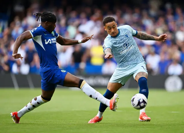 Marcus Tavernier of AFC Bournemouth passes the ball whilst under pressure from Noni Madueke of Chelsea during the Premier League match between Chelsea FC and AFC Bournemouth