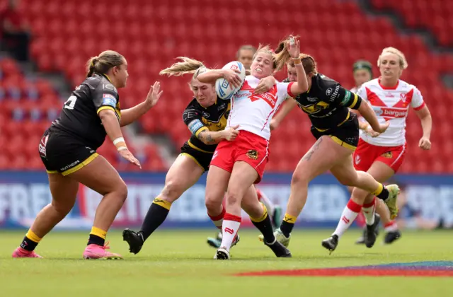 Tara Jones of St Helens is tackled by Alex Stimpson of York Valkyrie