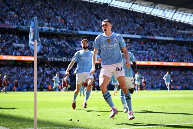 Phil Foden of Manchester City celebrates scoring his team's first goal during the Premier League match between Manchester City and West Ham United at Etihad Stadium