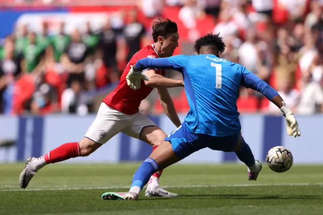 Chris Long takes on Crawley's Corey Addai