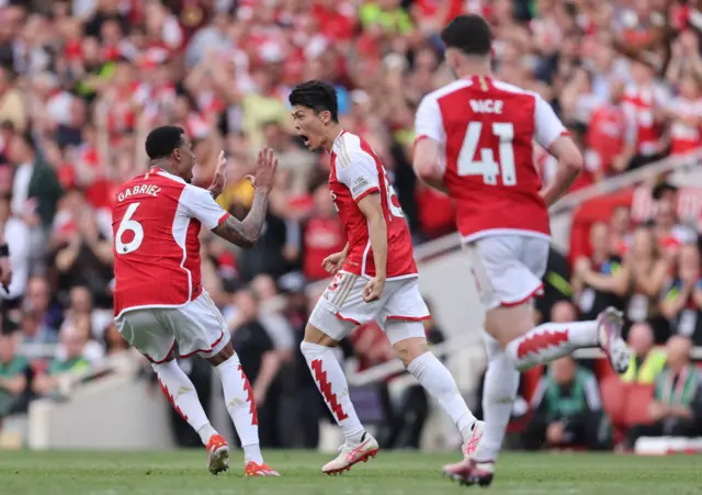 Takehiro Tomiyasu of Arsenal celebrates after scoring a goal to make it 1-1 during the Premier League match between Arsenal FC and Everton FC at Emirates Stadium