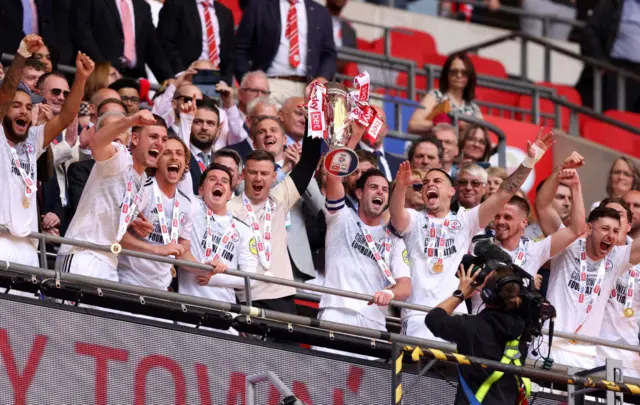 Crawley players lift the League Two play-off final trophy