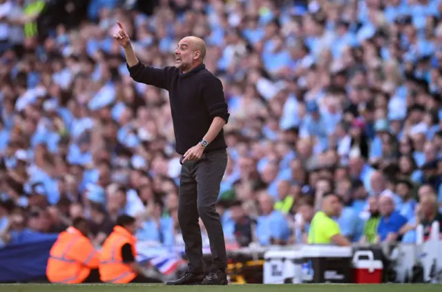 Manchester City's Spanish manager Pep Guardiola shouts instructions to the players from the touchline during the English Premier League football match between Manchester City and West Ham United at the Etihad Stadium