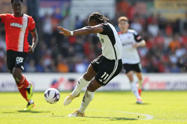 Adama Traore of Fulham scores his team's first goal during the Premier League match between Luton Town and Fulham FC at Kenilworth Road