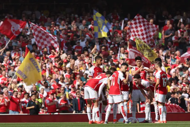 Arsenal players have a group chat on the pitch ahead of kick-off in the English Premier League football match between Arsenal and Everton at the Emirates Stadium