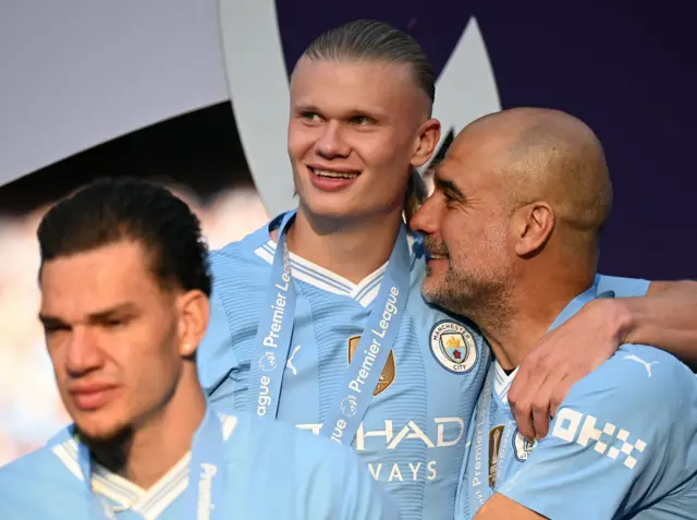 Manchester City's Spanish manager Pep Guardiola hugs Manchester City's Norwegian striker #09 Erling Haaland during the Premier League trophy presentation ceremony following the English Premier League football match between Manchester City and West Ham United