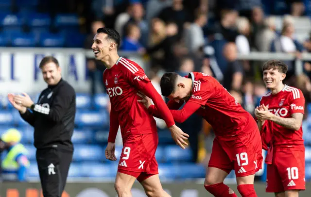 Aberdeen's Bojan Miovski (L) and Slobodan Rubezic at full time during a cinch Premiership match between Ross County and Aberdeen at the Global Energy Stadium, on May 19, 2024, in Dingwall, Scotland.