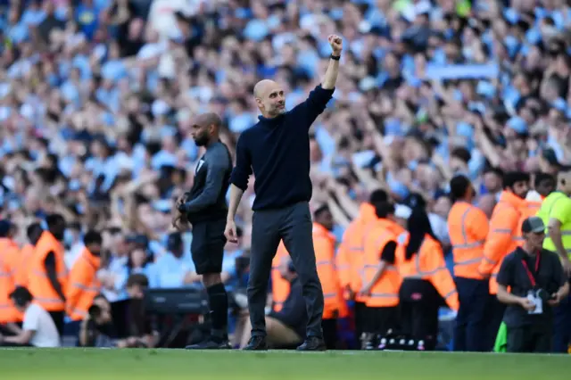 Pep Guardiola, Manager of Manchester City, acknowledges the fans as he celebrates during the Premier League match between Manchester City and West Ham United