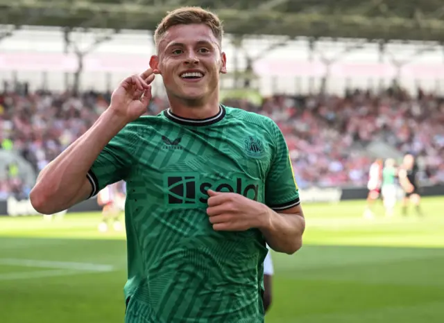 Harvey Barnes of Newcastle United (15) celebrates after scoring the opening goal during the Premier League match between Brentford FC and Newcastle United at Brentford Community Stadium on May 19, 2024 in Brentford