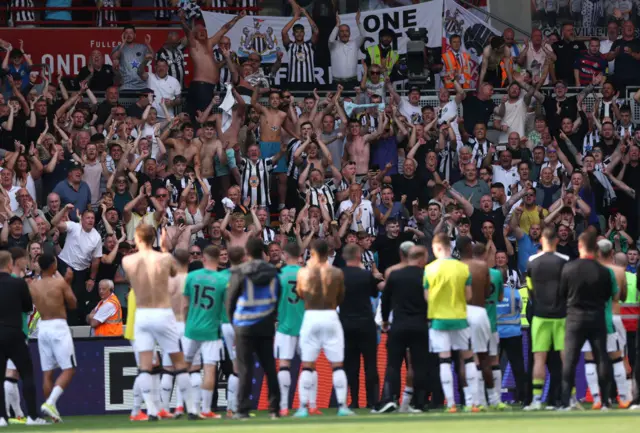 Newcastle United fans show their support in the stands as the players look on after the Premier League match between Brentford FC and Newcastle United at Brentford Community Stadium