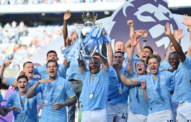 Kyle Walker of Manchester City lifts the Premier League Trophy after their team's victory during the Premier League match between Manchester City and West Ham United at Etihad Stadium