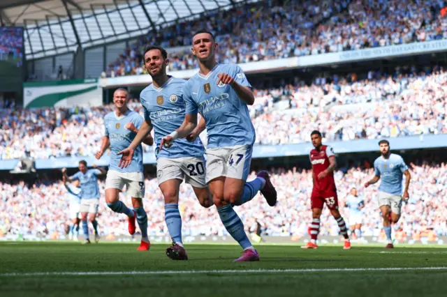 Phil Foden of Manchester City celebrates after scoring a goal to make it 2-0 during the Premier League match between Manchester City and West Ham United at Etihad Stadium