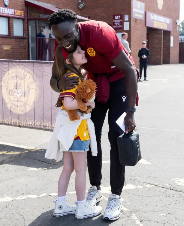 Motherwell's Bevis Mugabi with a young fan before a cinch Premiership match between Motherwell and St Johnstone at Fir Park