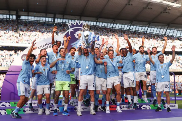 Kyle Walker of Manchester City lifts the Premier League Trophy after their team's victory during the Premier League match between Manchester City and West Ham United at Etihad Stadium