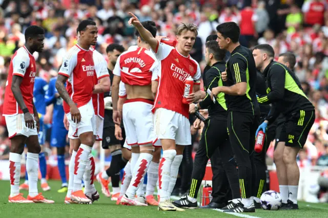 Carlos Cuesta speaks to Martin Odegaard of Arsenal during the Premier League match between Arsenal FC and Everton FC at Emirates Stadium