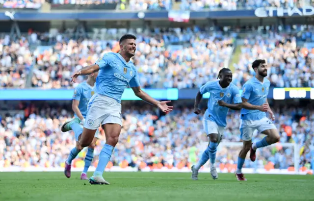 Rodri of Manchester City celebrates scoring his team's third goal during the Premier League match between Manchester City and West Ham United at Etihad Stadium