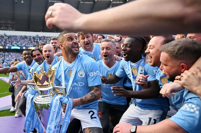 Kyle Walker of Manchester City prepares to lift The Premier League Trophy