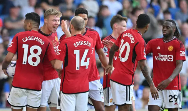 Manchester United's Danish striker #11 Rasmus Hojlund (2L) celebrates scoring the team's second goal during the English Premier League football match between Brighton and Hove Albion and Manchester United at the American Express Community Stadium