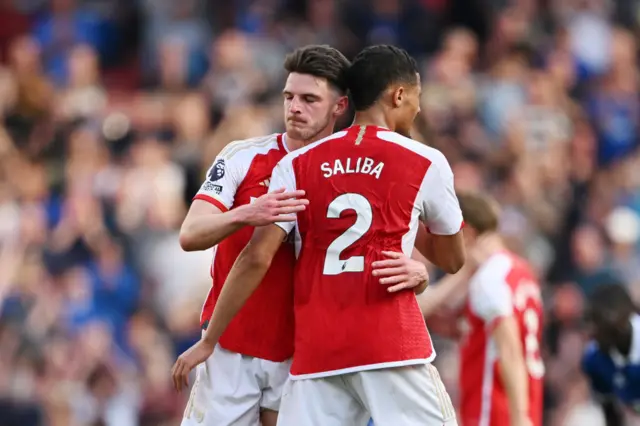 Declan Rice of Arsenal looks dejected as he embraces teammate William Saliba following the Premier League match between Arsenal FC and Everton FC