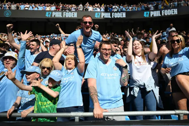 Fans of Manchester City celebrate after Phil Foden of Manchester City (not pictured) scores his team's first goal during the Premier League match between Manchester City and West Ham United at Etihad Stadium