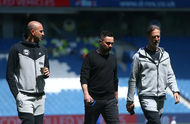 Roberto De Zerbi, and Andrea Maldera, Assistant Manager of Brighton & Hove Albion inspect the pitch