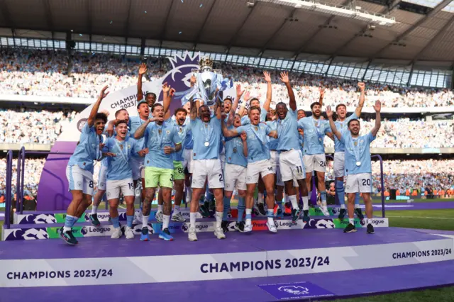 Kyle Walker of Manchester City lifts the Premier League Trophy after their team's victory during the Premier League match between Manchester City and West Ham United at Etihad Stadium