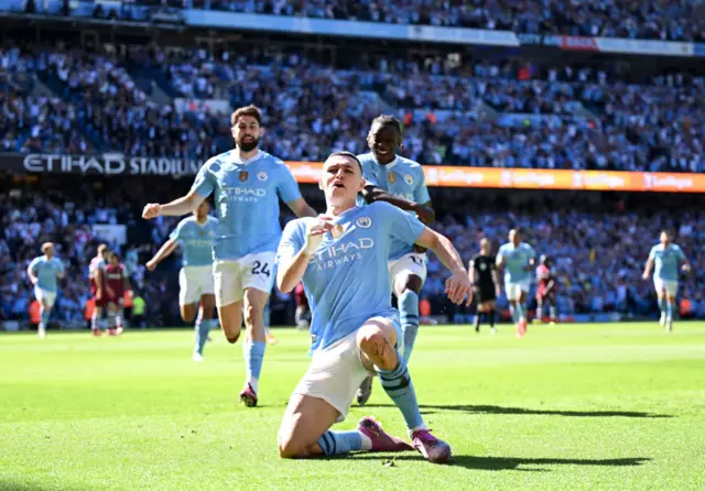 Phil Foden of Manchester City celebrates scoring his team's first goal during the Premier League match between Manchester City and West Ham United at Etihad Stadium