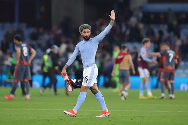 Douglas Luiz of Aston Villa acknowledges the home support