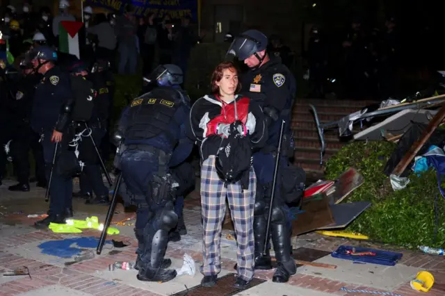 Law enforcement officers detain a protester at the University of California Los Angeles